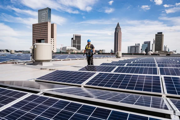 Arbeiter auf einem Dach mit vielen Photovoltaikanlagen
